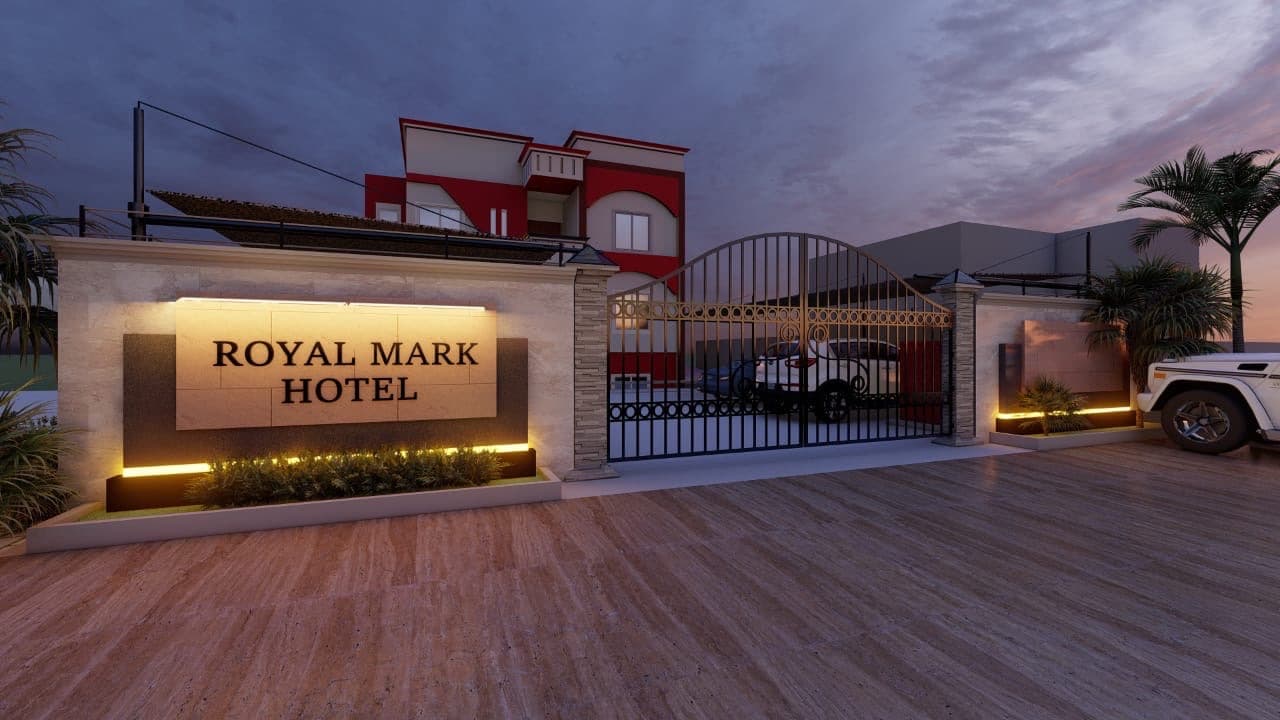 The illuminated entrance and signage of Royal Mark Hotel at dusk